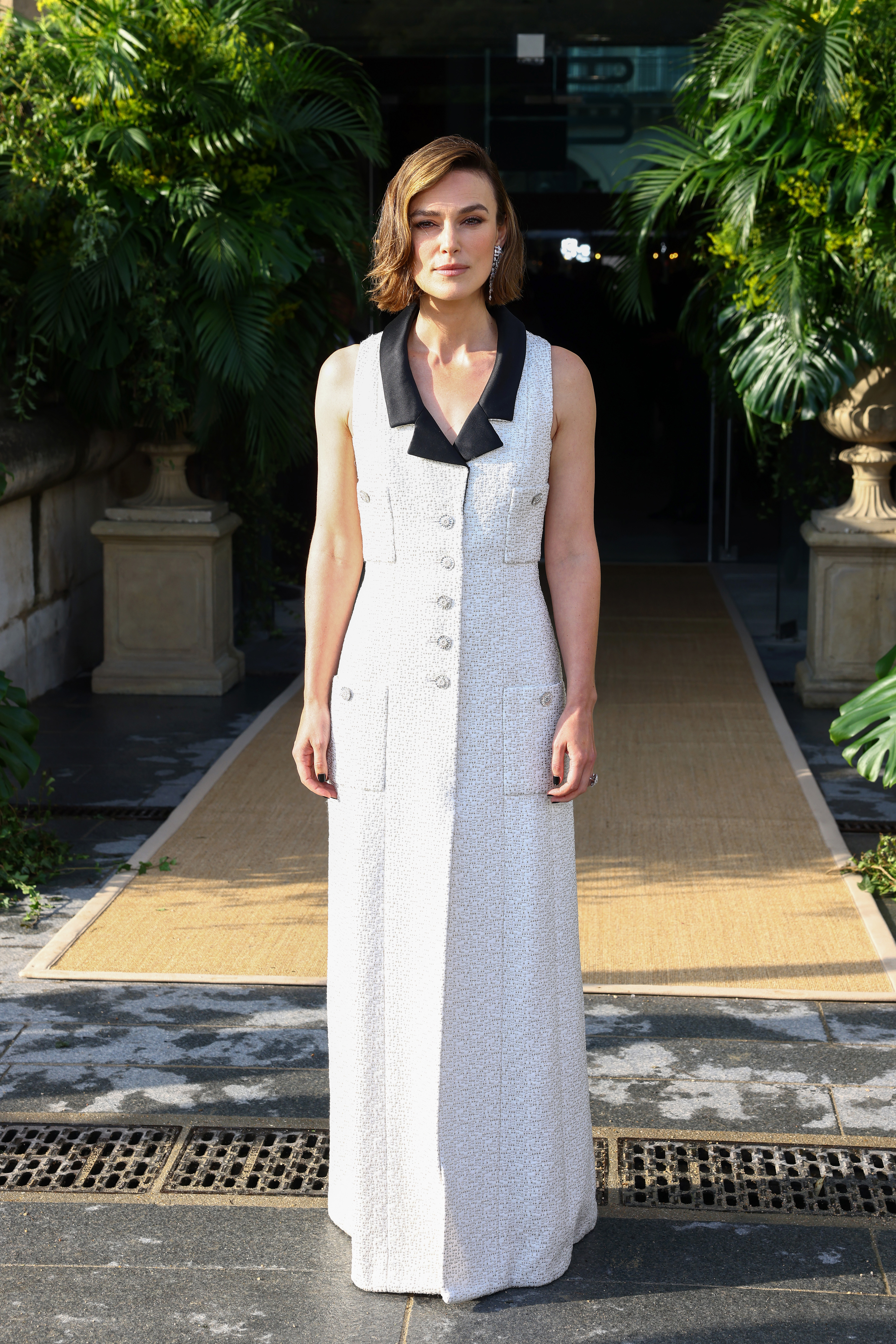 Keira Knightley with a bob hairstyle that has a deep side part.