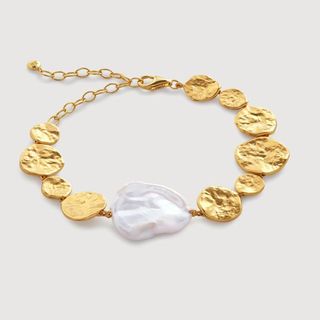 flat lay of gold pearl bracelet 