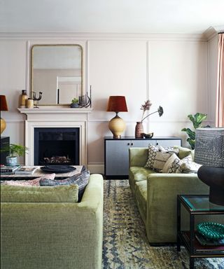 Pale pink living room with green velvet couches