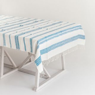 Blue striped tablecloth on white table