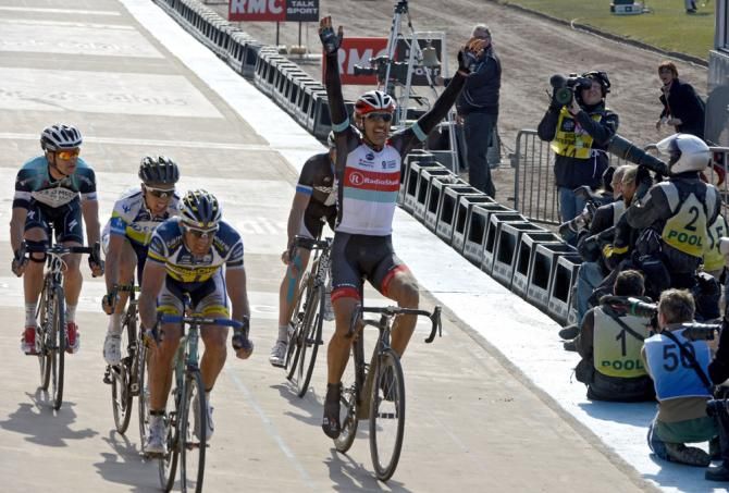 Fabian Cancellara bursts through the crowd to win his third Paris-Roubaix