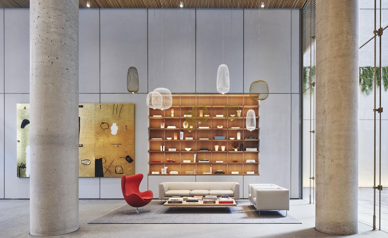 Living area with storage shelves and red chair