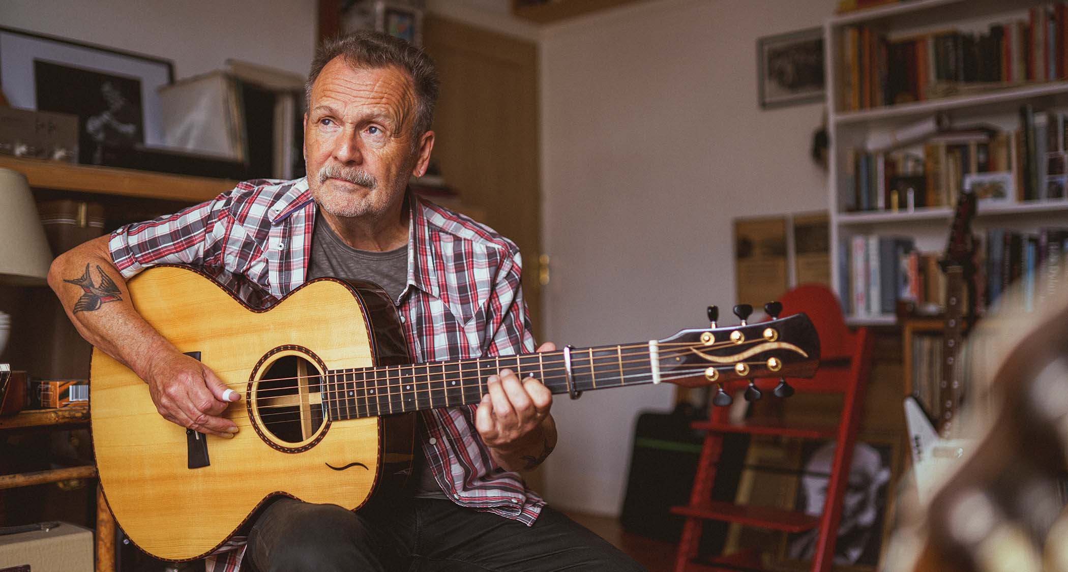 Martin Simpson at home with his acoustic guitar