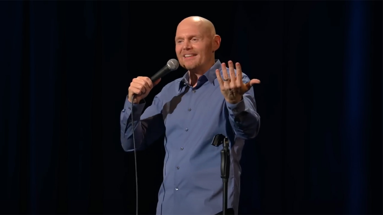 Bill Burr threatening to quit with one arm in the air in Paper Tiger.