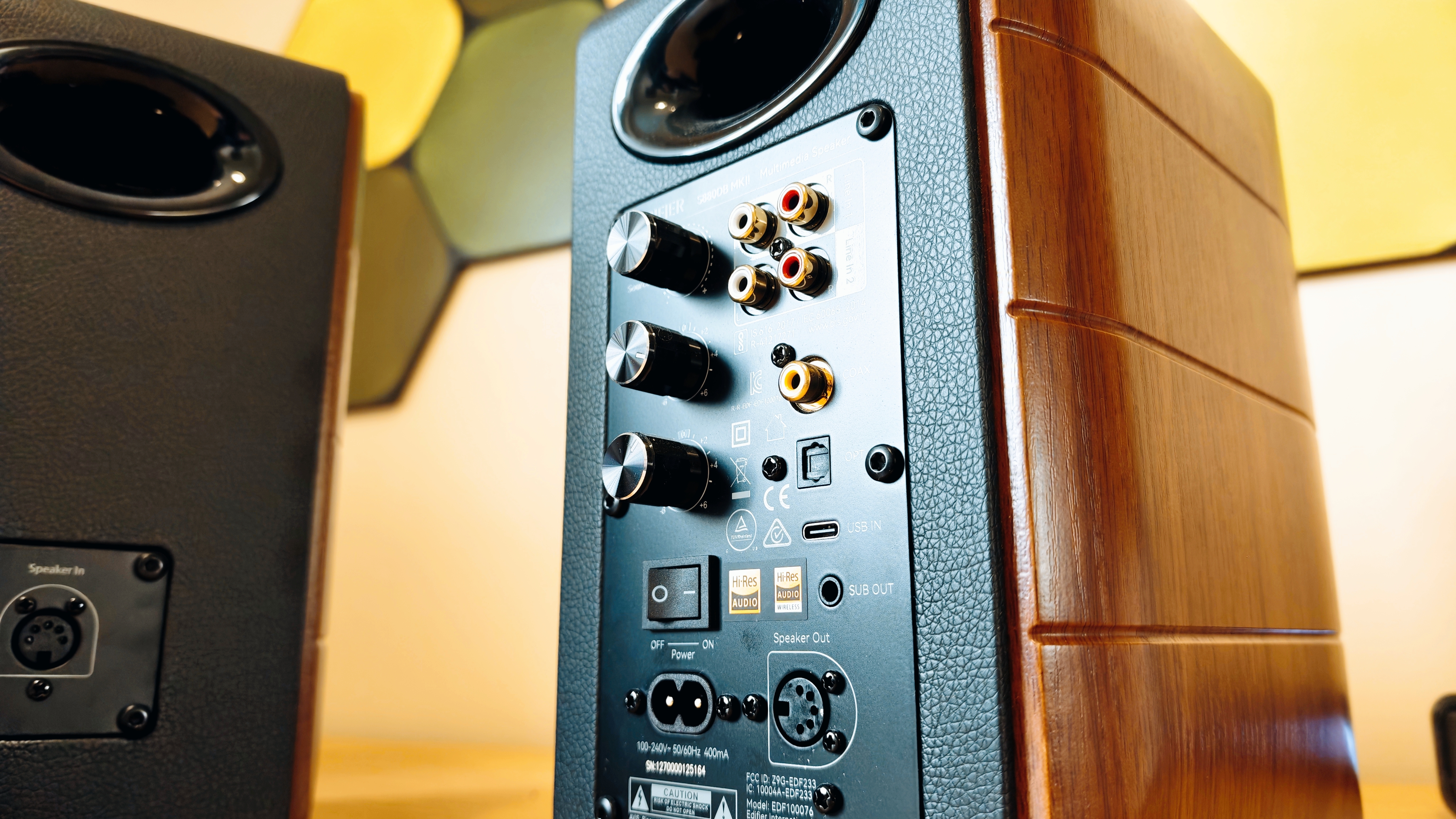Black and brown Edifier S880DB MkII speakers on a wooden desk