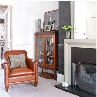 living room with leather armchair and fire place