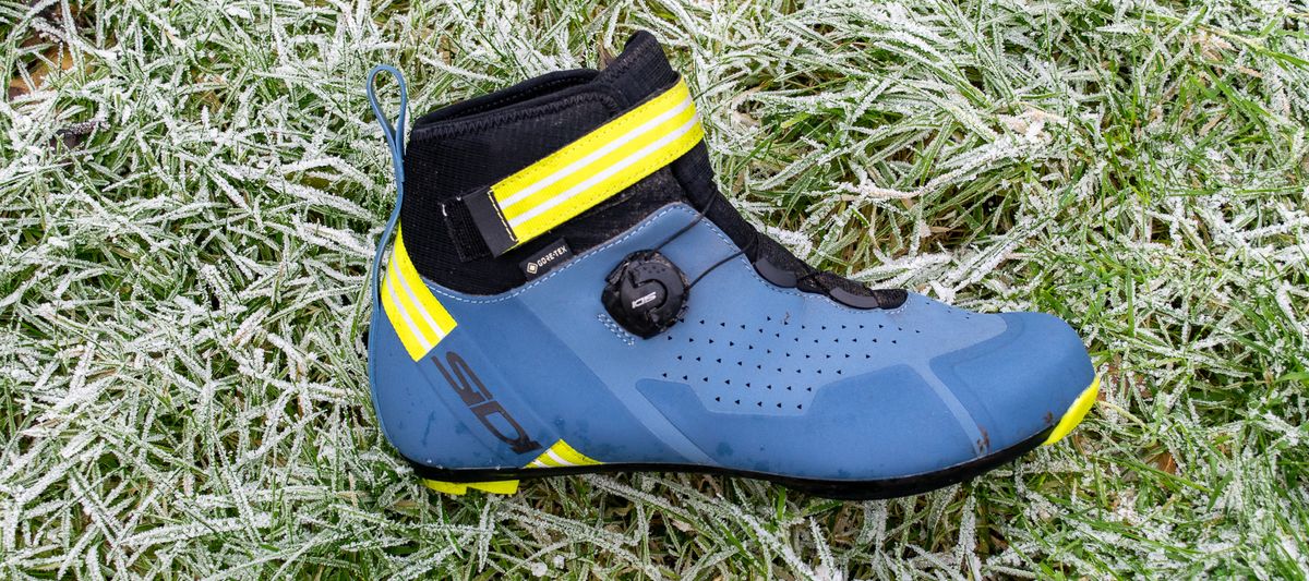 A blue Sidi Nix winter boot on frosty grass 