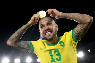 Dani Alves celebrates with his gold medal after Brazil's win over Spain in the final of the men's football tournament at the 2020 Olympic Games in Tokyo.