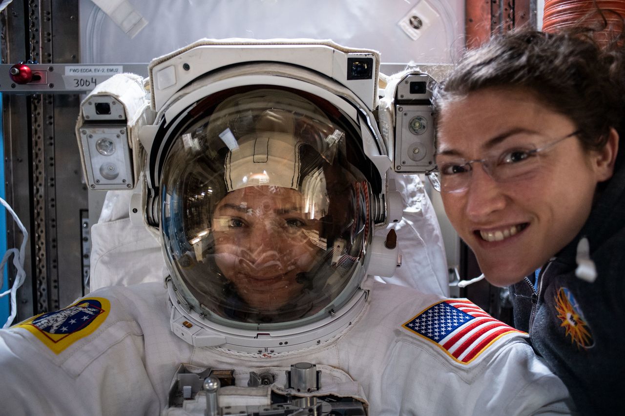 NASA astronauts Jessica Meir (center) and Christina Koch pose for a photo while preparing for an Oct. 18, 2019 spacewalk.