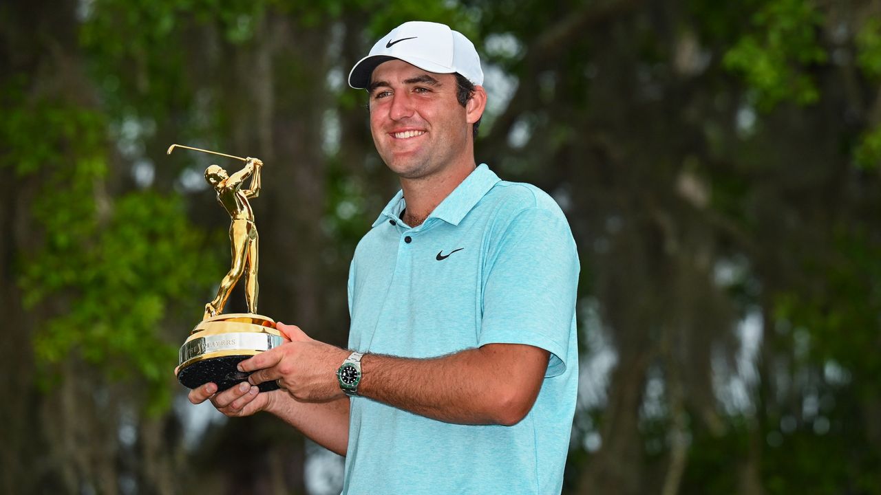 Scottie Scheffler with the trophy after his win at the 2023 Players Champiosnship