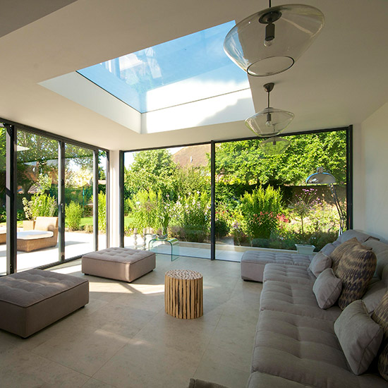 Glass extension with beige sofa set and stools