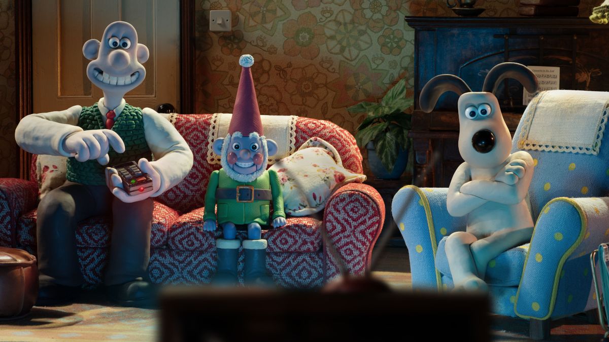 A happy Norbot watches TV between Wallace and Gromit in Wallace and Gromit: Vengeance Most Fowl.