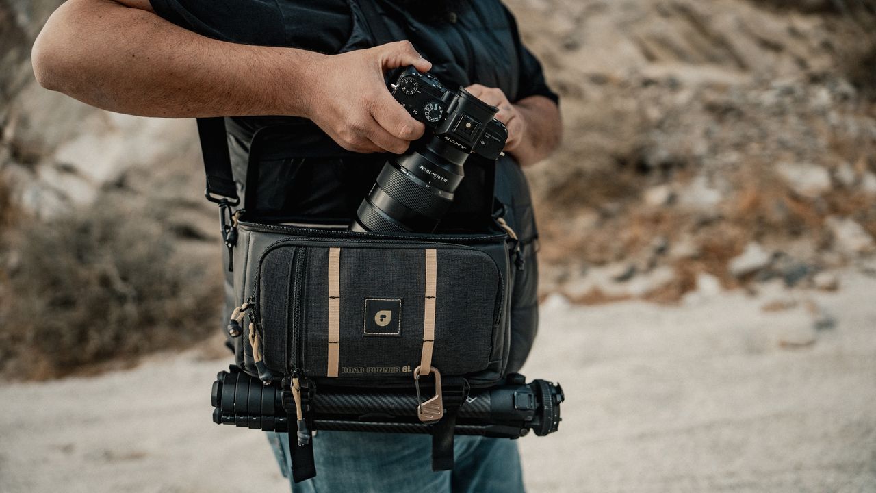 The PolarPro RoadRunner Shoulder Bag with a tripod and a camera