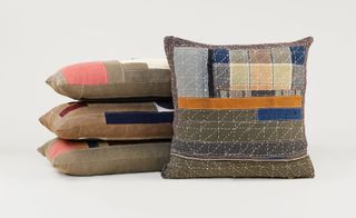 Four brown cushions with patches of different colours and textures