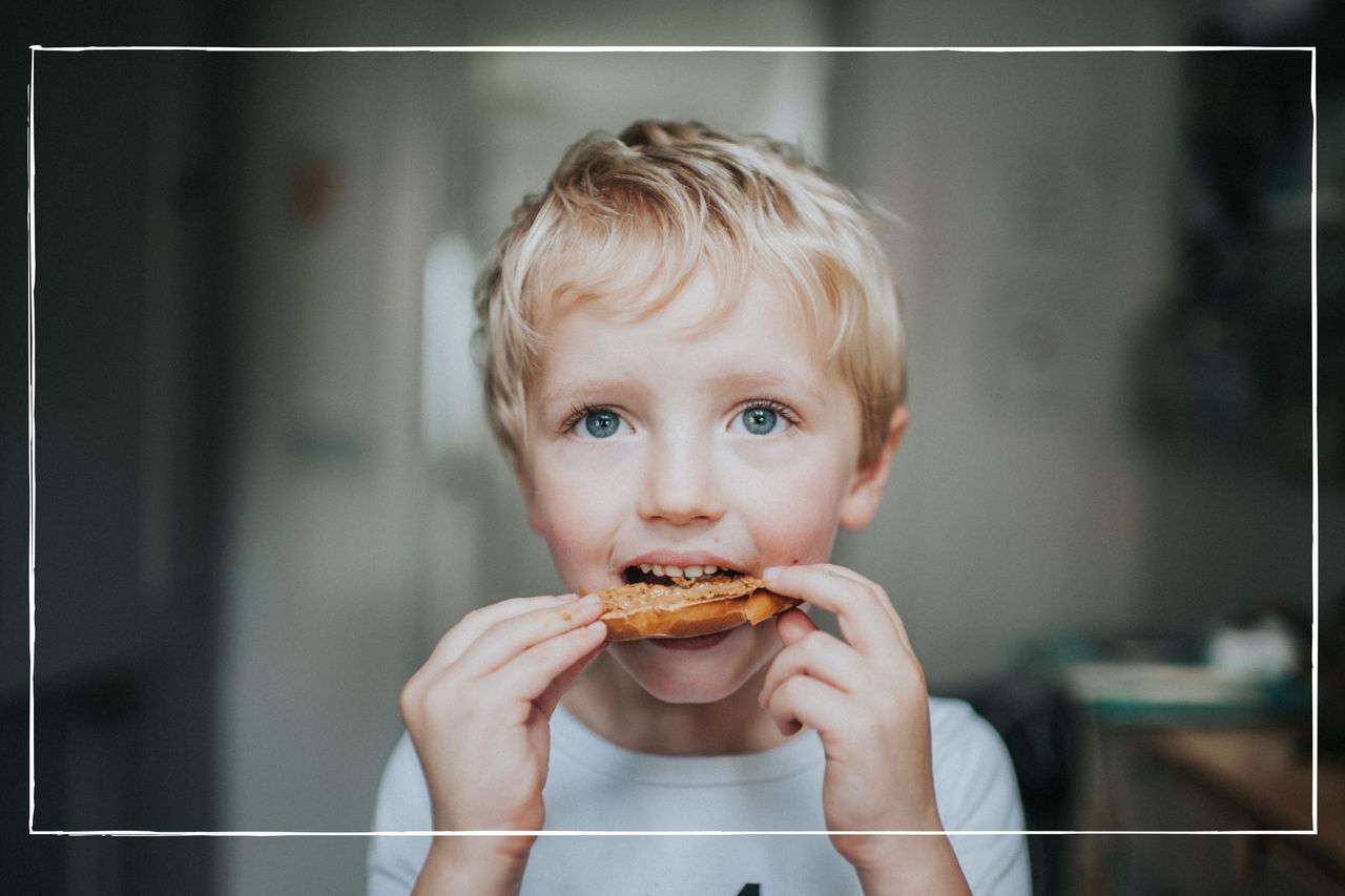 young boy eating a bagel