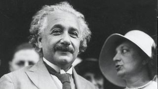Albert Einstein smiles in a black and white photograph