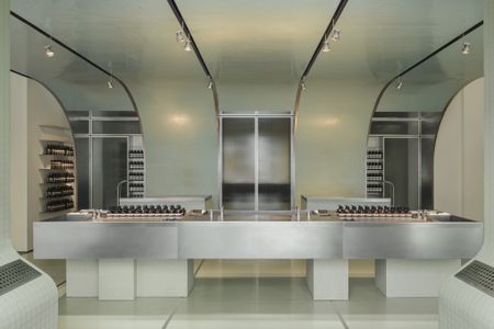 aesop milan store interior showing minimalist table with product