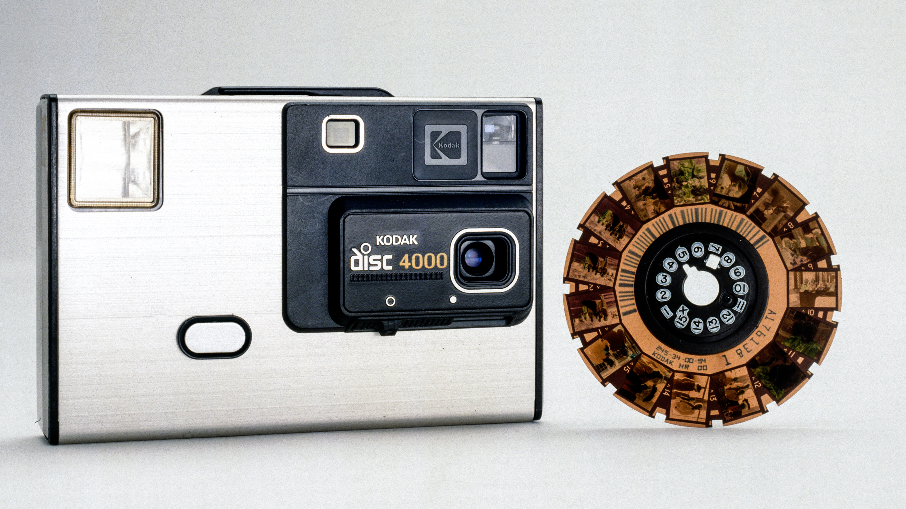 UNITED KINGDOM - JULY 09: Having previously pioneered other innovations for amateur snapshot photographers such as the Instamatic camera and the 110 cartridge film camera, Kodak brought out its disc camera and film in 1982. The camera was designed to capitalise on the popularity of the operational simplicity and quick and easy film loading characterisics of Instamatics, combined with advances in film technology. In practice, the very small (8mm x 10mm) size of the negatives produced with disc film was unpopular, and Kodak stopped producing cameras for this format in 1990. Production of disc films ended in 1998. The 4000 disc camera had an aspheric lens of a type patented by Kodak, and featured a low-light sensor to automatically activate the flash. (Photo by SSPL/Getty Images)