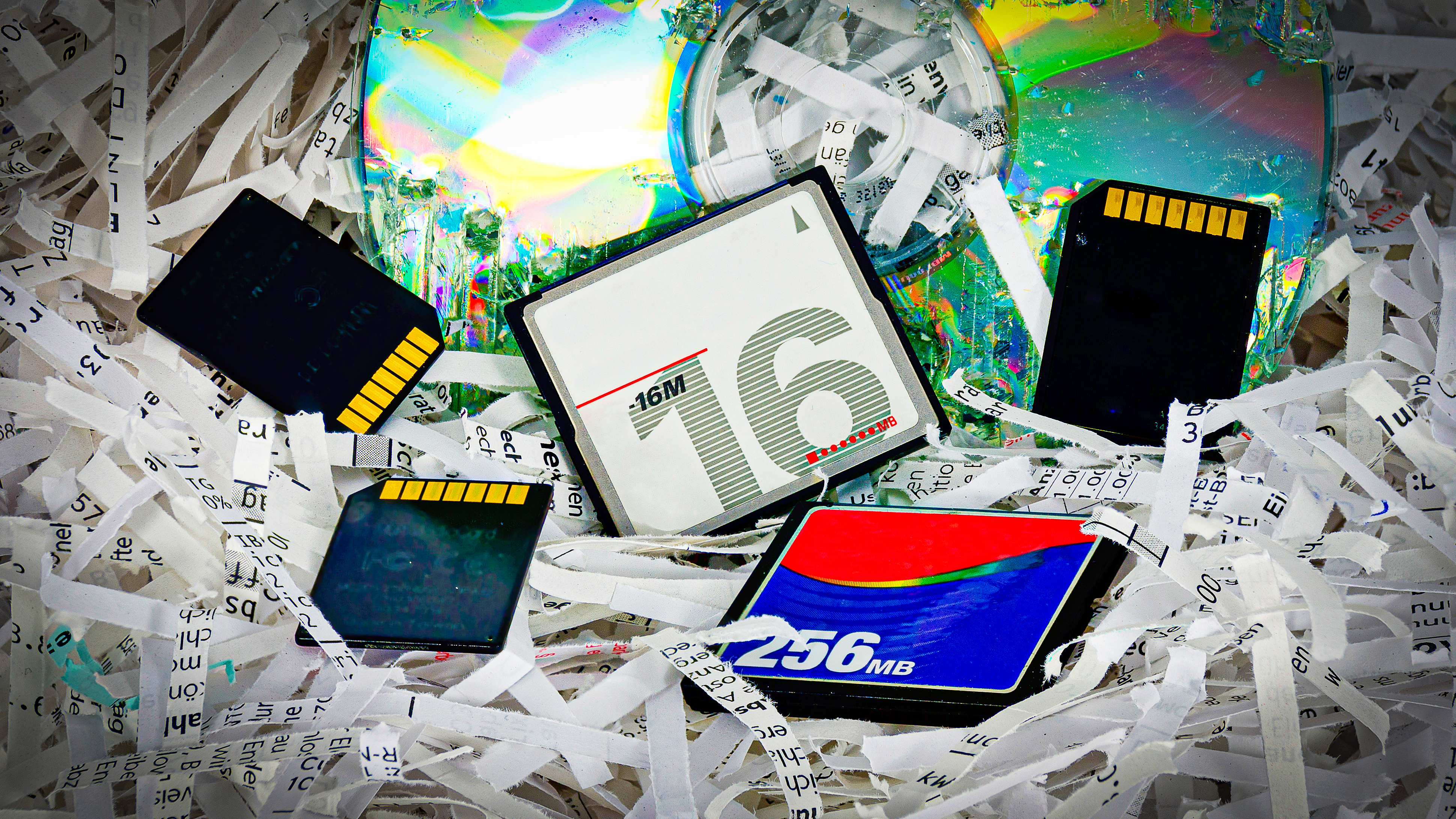 Old memory cards on a pile of shredded paper