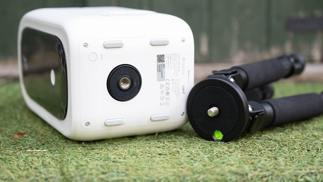 ZWO Seestar S50 Pro on a tripod against a green shed