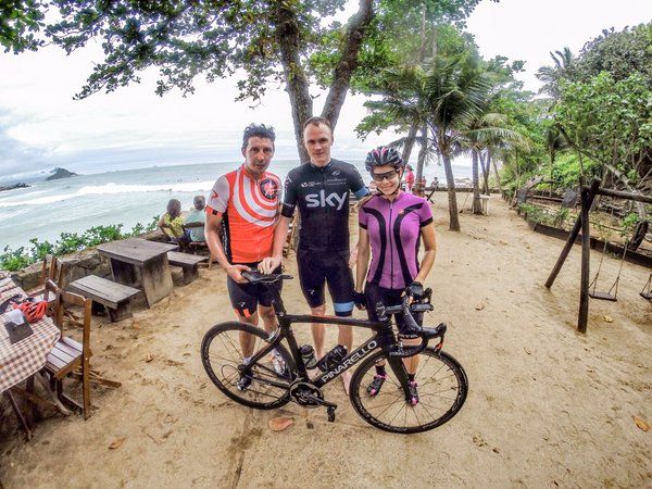 Chris Froome poses for a photo with local riders who helped during his visit to Rio.