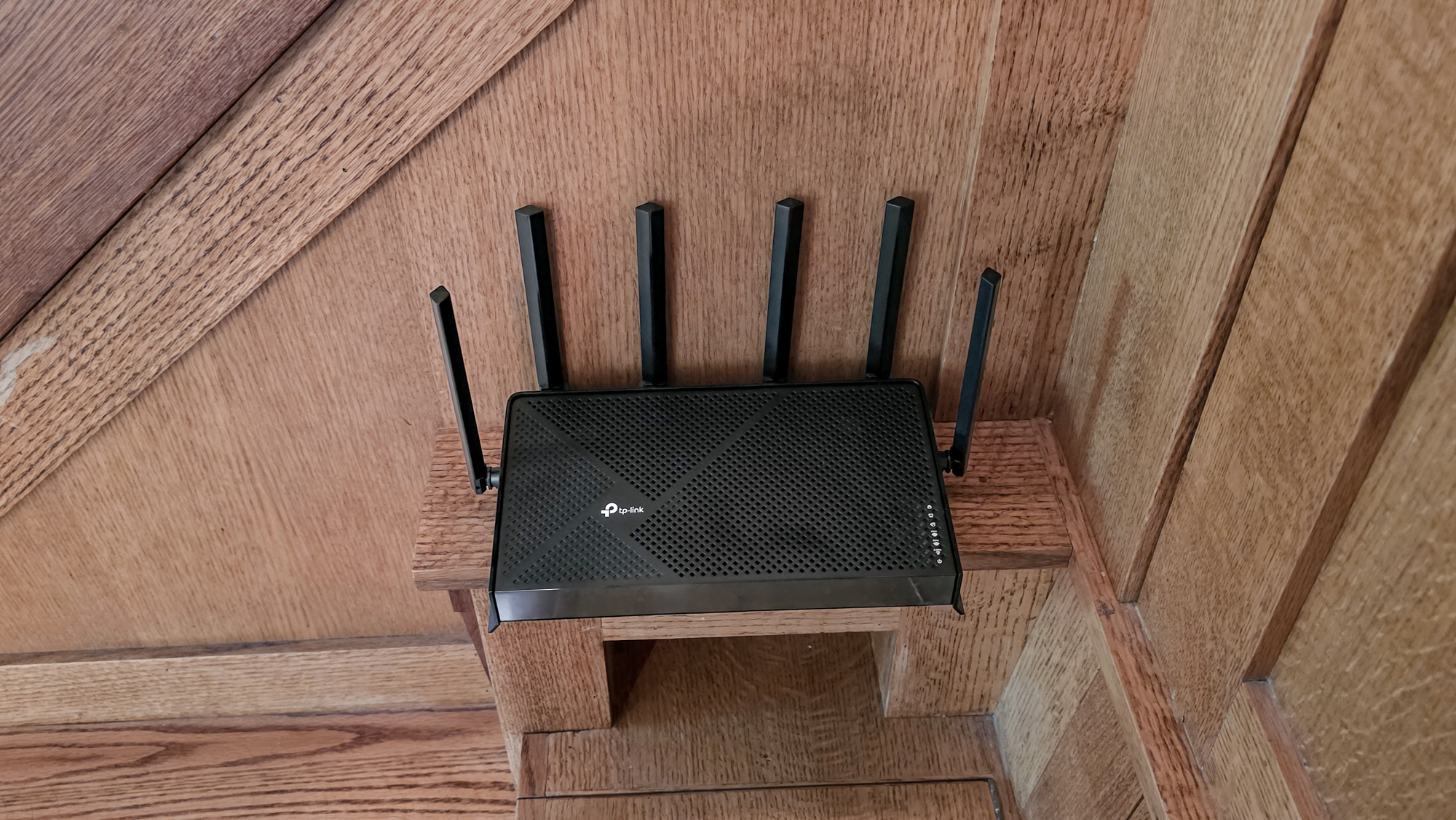 TP-Link Archer BE9700 router on a shelf