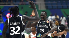 Members of South Sudan's basketball team celebrate after winning a world cup match against Angola last year