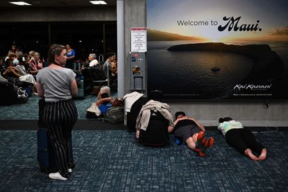 Travelers wait to leave Maui during deadly wildfires