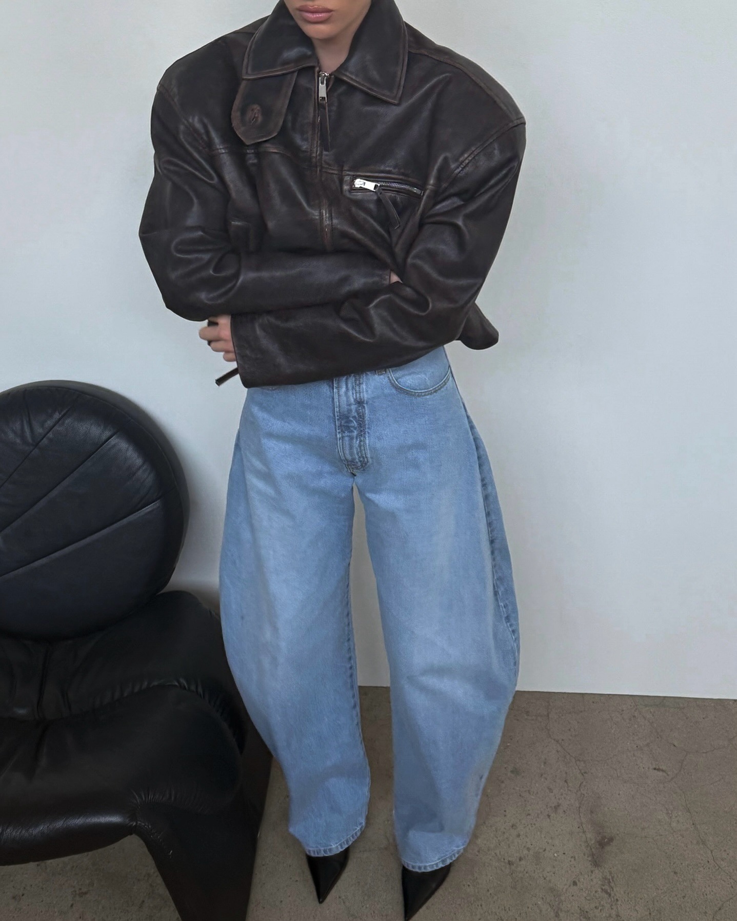 Elsa Hosk wearing a distressed leather jacket with barrel jeans.