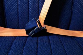 Blue car seat and orange seatbelt