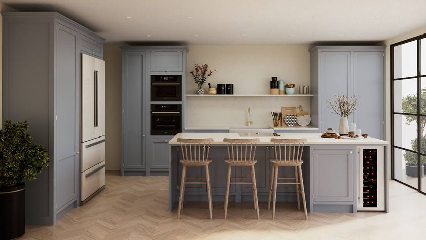 light blue kitchen with floor to ceiling cabinet and an island