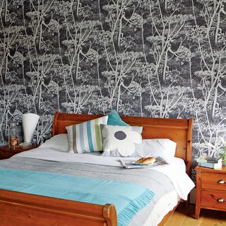 bedroom with graphic floral wallpaper and bed