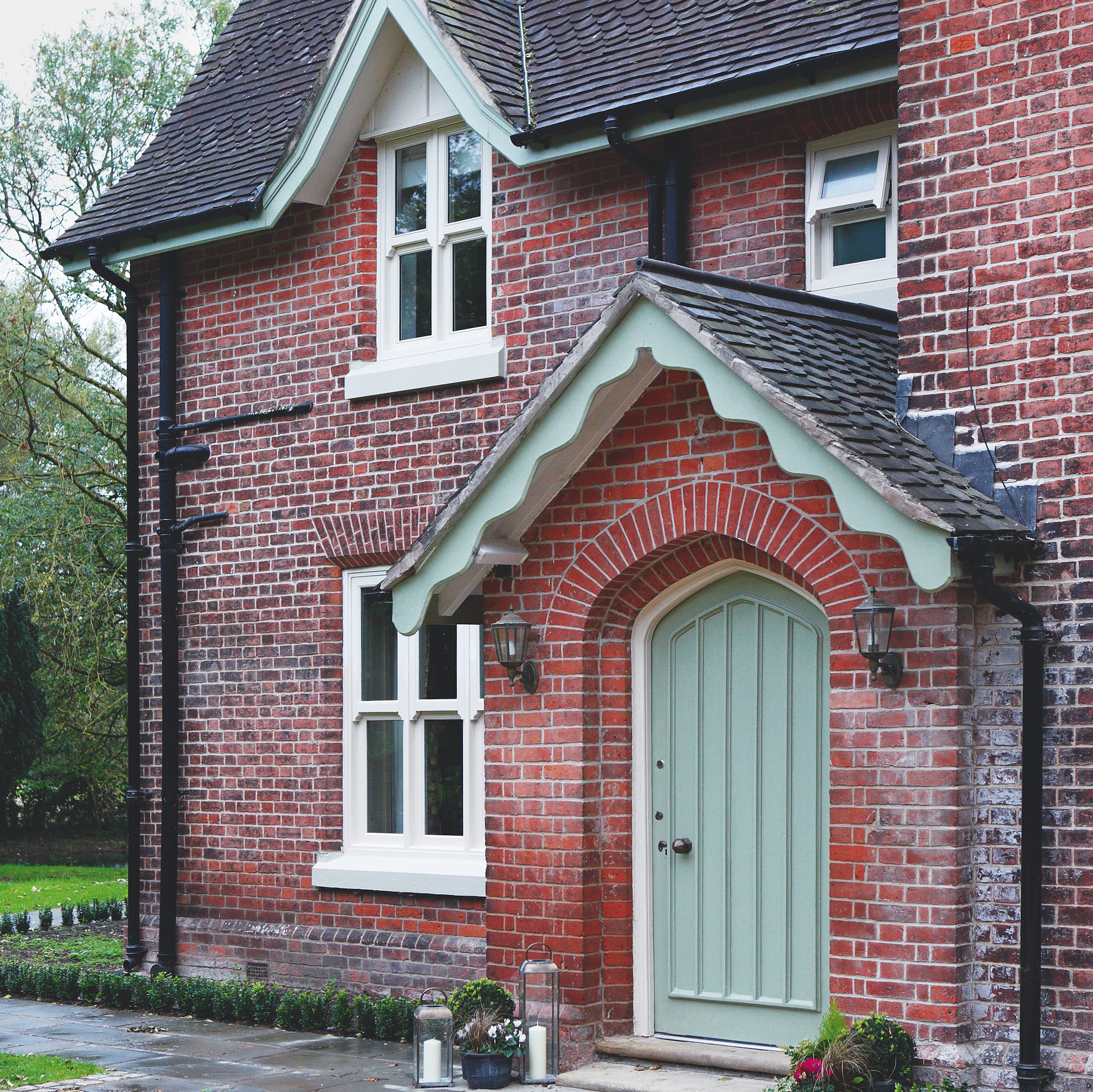exterior of brick built victorian vicarage with pitched roof porch with green front door