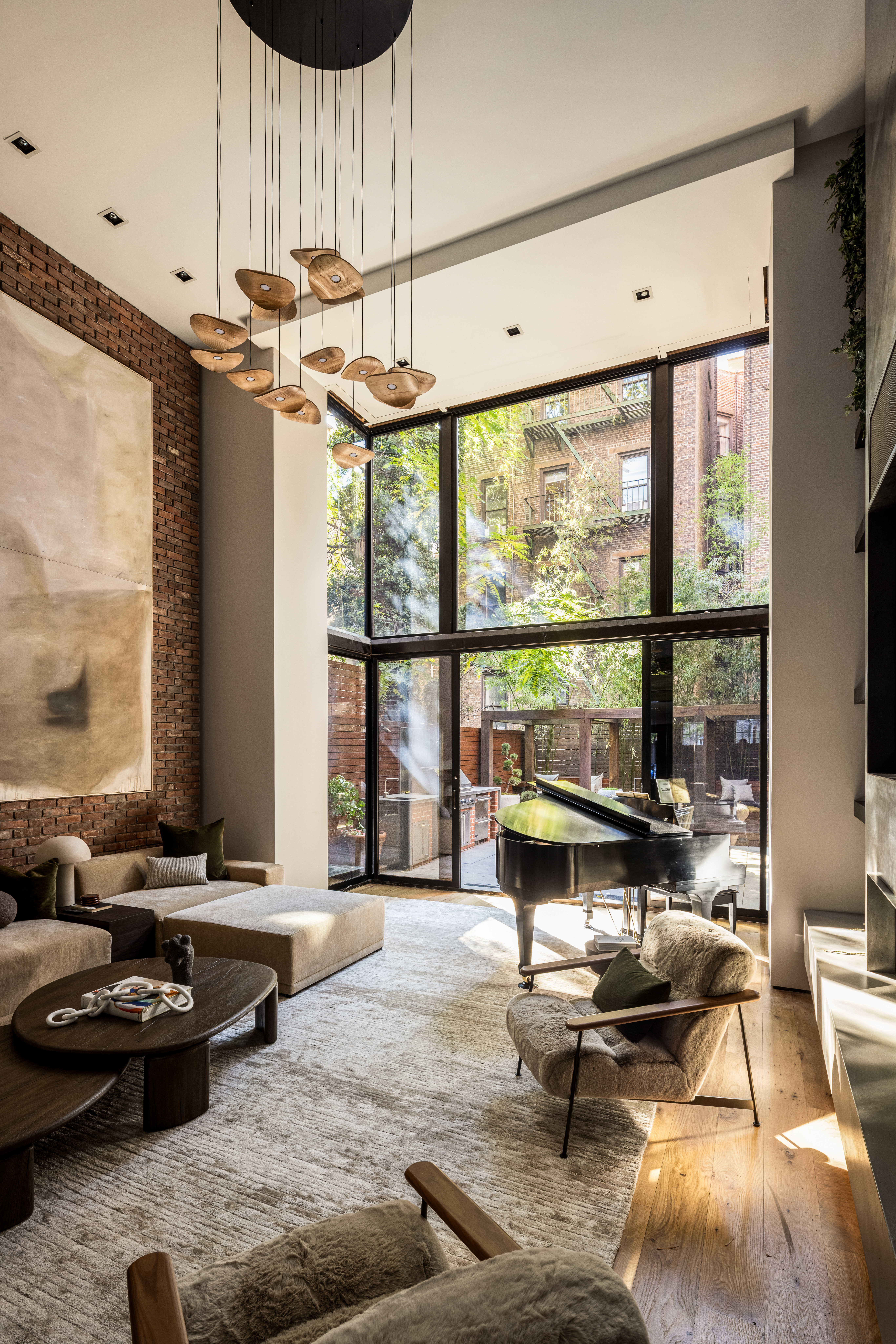 Unfinished living room of the Kips Bay Decorator Show House New York 2026, set in a landmark Greenwich Village townhouse with brick walls, sweeping ceilings, and cozy industrial furniture