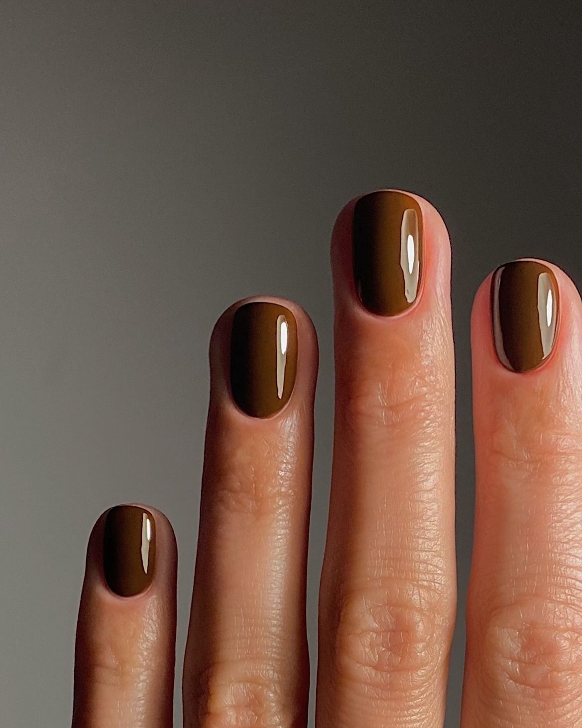 A close-up picture of a chestnut brown manicure