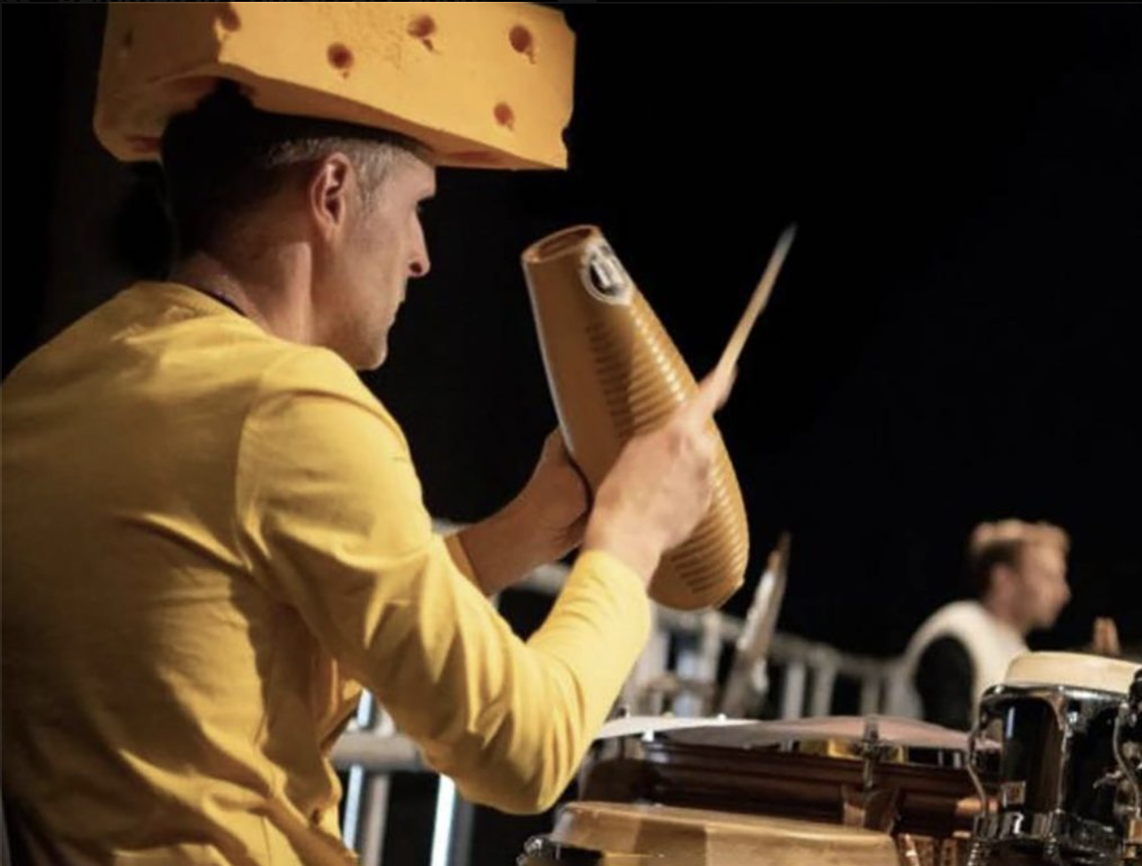 an image of one of the percussionists from the orchestra dressed as a block of cheese whilst performing