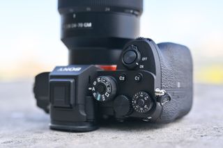 The top plate now sports the rear command dial, which was only half exposed on the A7R III, while there's a locking button on the exposure compensation dial on the right-hand side