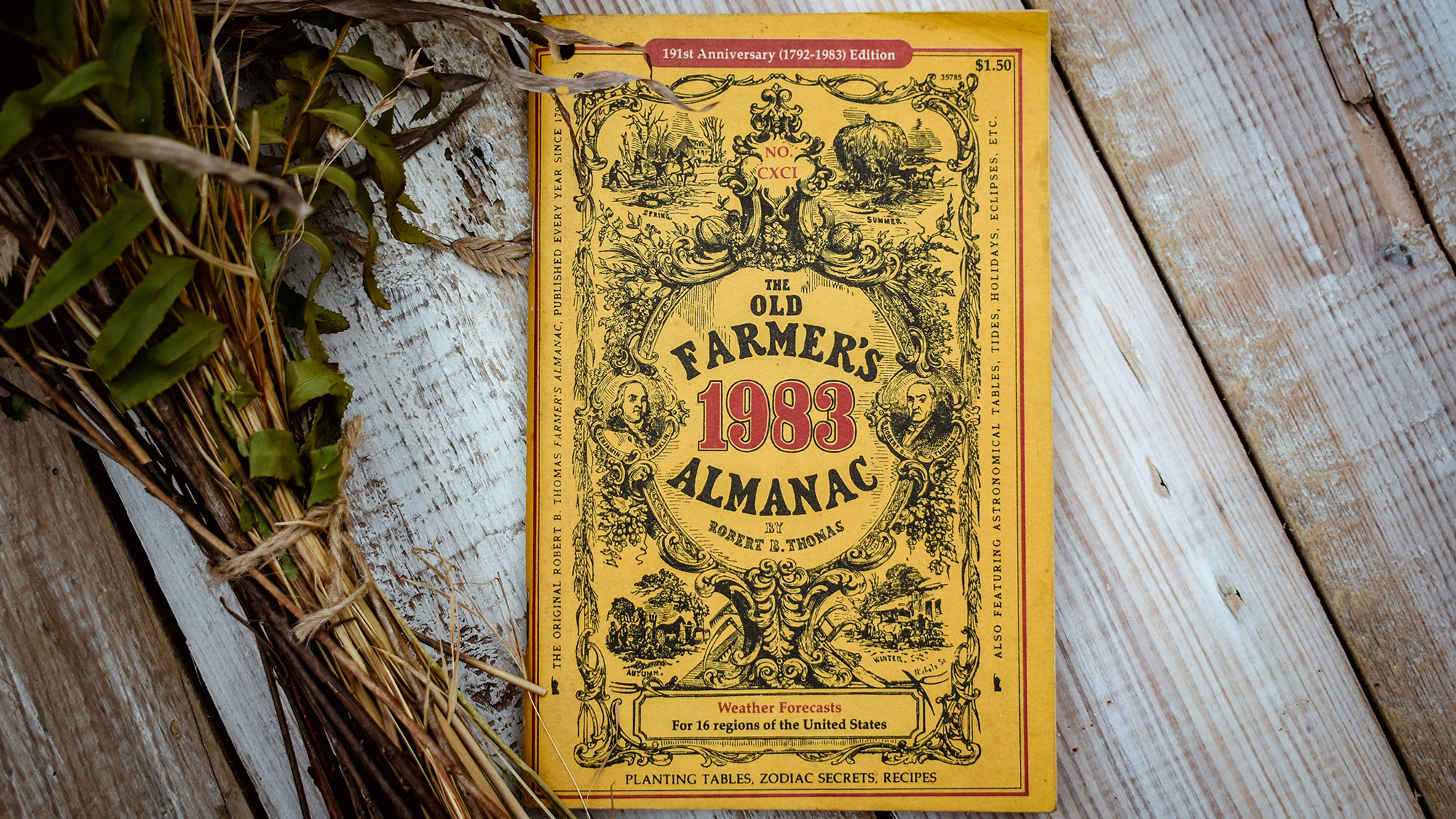 Black Fork, Arkansas, USA- September 1, 2020- A vintage 1983 yellow farmers almanac sitting on top of a table with some dried flowers beside it