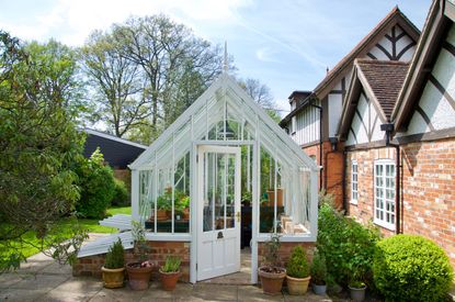 Monty Don garden ideas: White greenhouse set in a courtyard