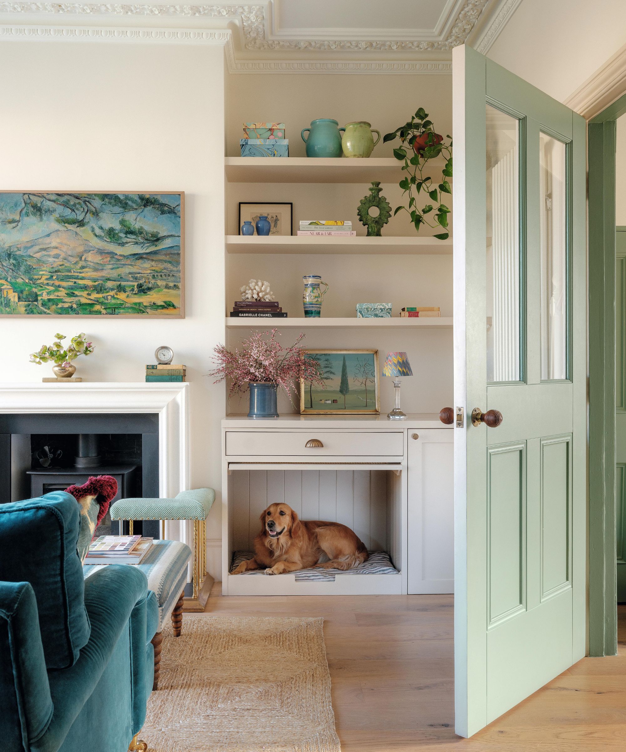 a pale pink sitting room with custom alcove storage cleverly housing a bespoke dog bed