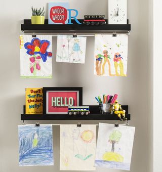 kids room with artwork hanging from floating shelves
