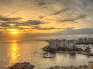 A sunrise view of the water and Santurce neighborhood in San Juan, Puerto Rico