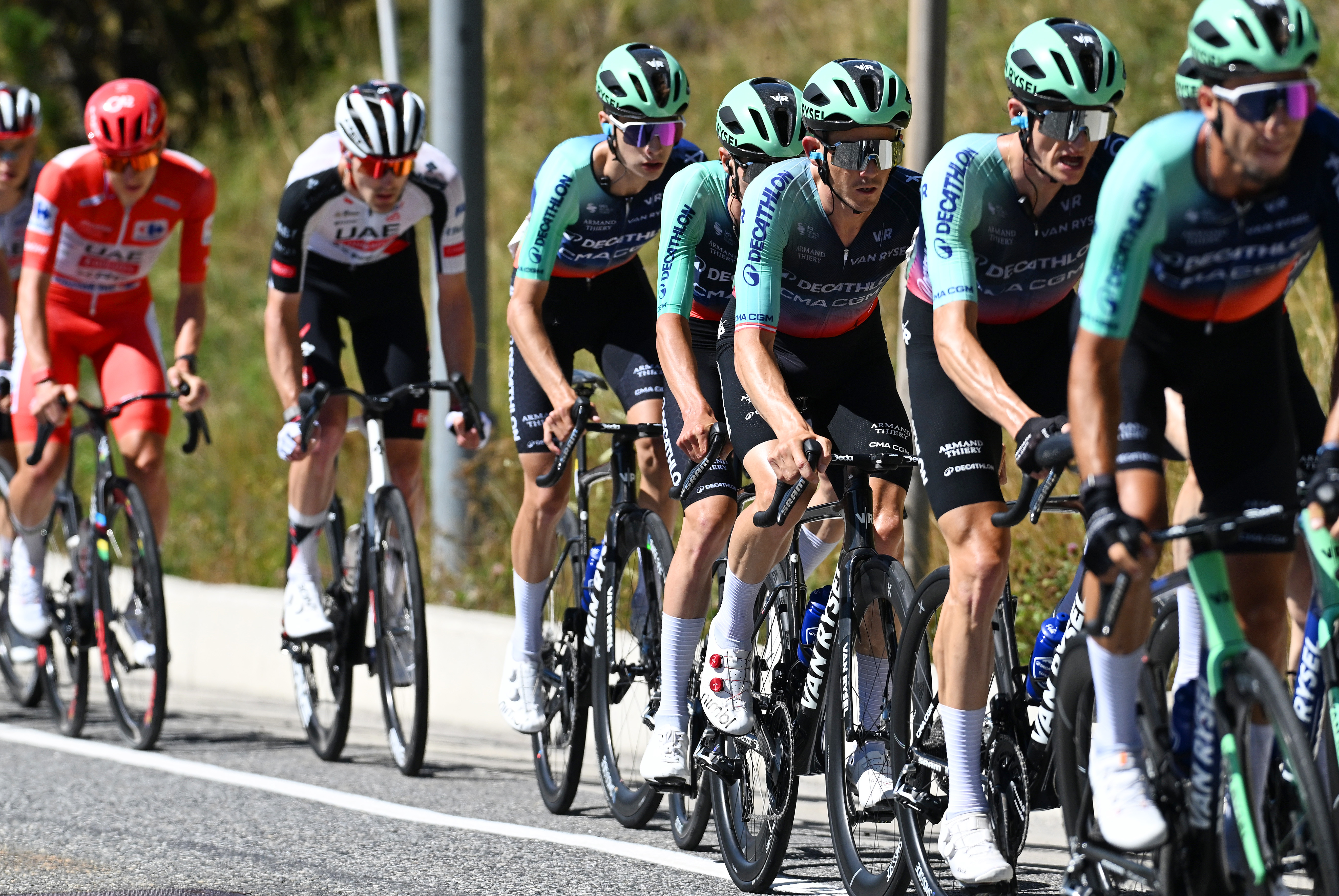 Five riders from Decathlon CMA CGM lead the peloton during stage 4 of the 2026 Vuelta a Espa&amp;ntilde;a ahead of race leader Tadej Poga&amp;#269;ar on the road to Andorra la Vella