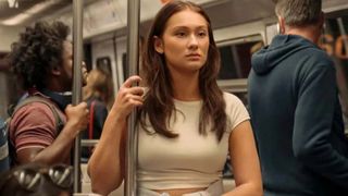 Belly holds onto a rail while on the subway