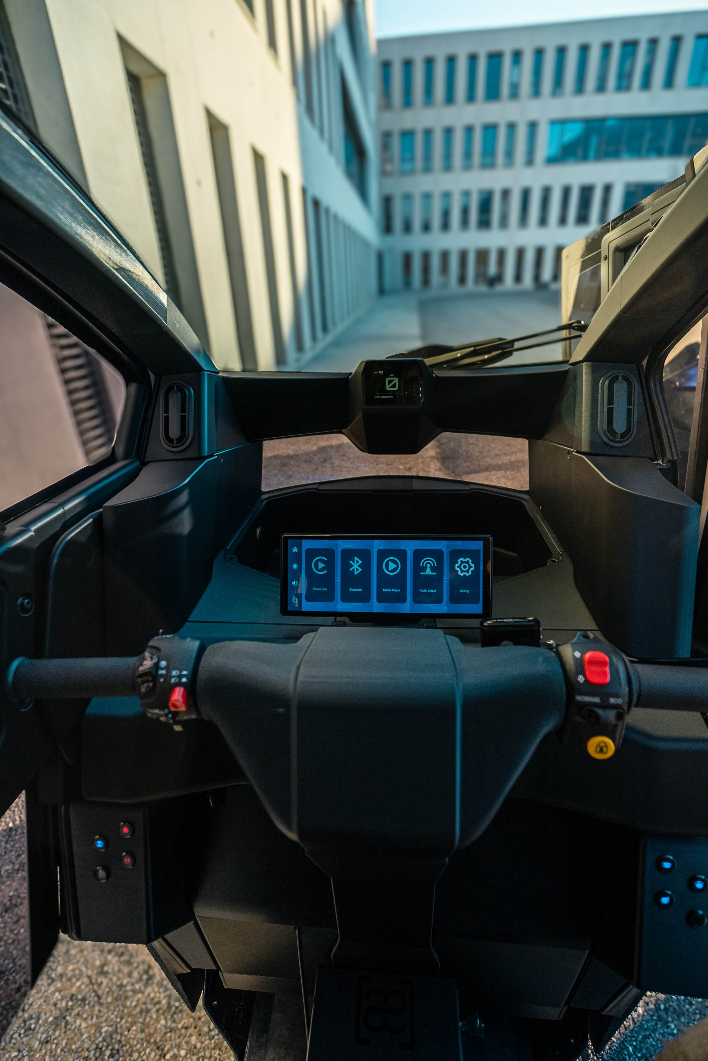 Inside the Aemotion two-seater, with the handlebar controls