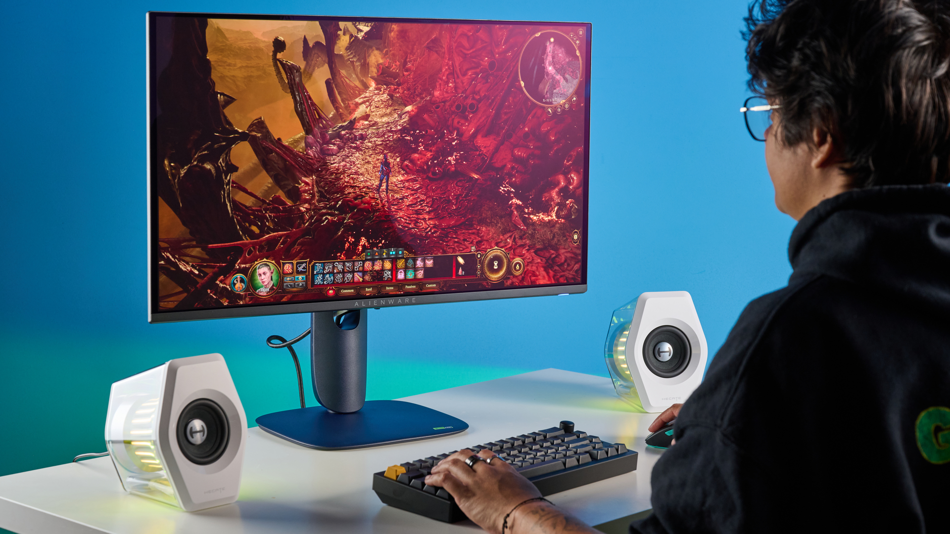 Alienware AW2725D on a desk against a blue background