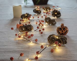 ZHONGXIN Halloween Pumpkin Lights on table atop white tablecloth