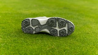 A detailed look at the spiked outsole of the Ram Golf XT1 Men's waterproof golf shoe