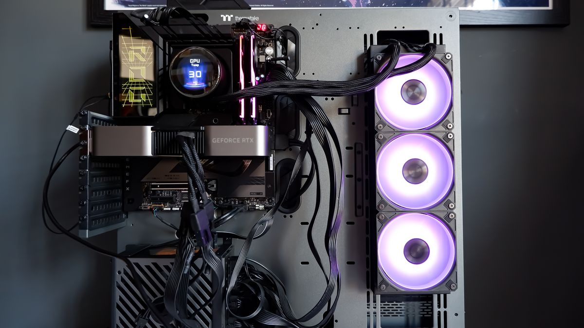 An MSI MPG CoreLiquid P13 all-in-one liquid cooler on a desk and installed onto a test bench for testing.