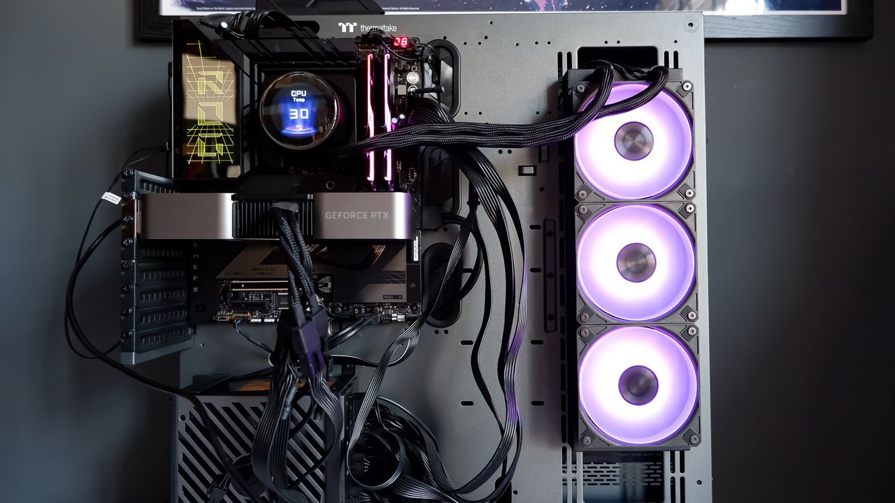 An MSI MPG CoreLiquid P13 all-in-one liquid cooler on a desk and installed onto a test bench for testing.